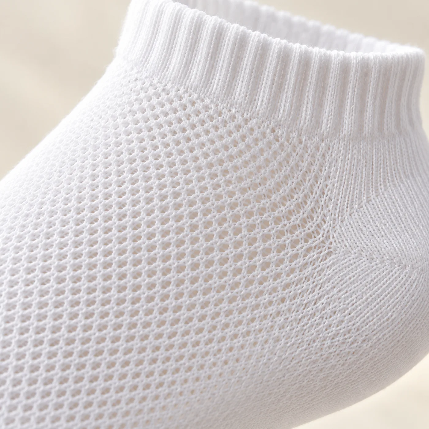 Close-up of fine white sock mesh and ribbed cuff